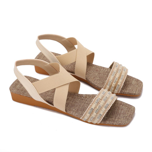 Elegant women's sandals with elastic straps and a design decorated with threads and beads.
