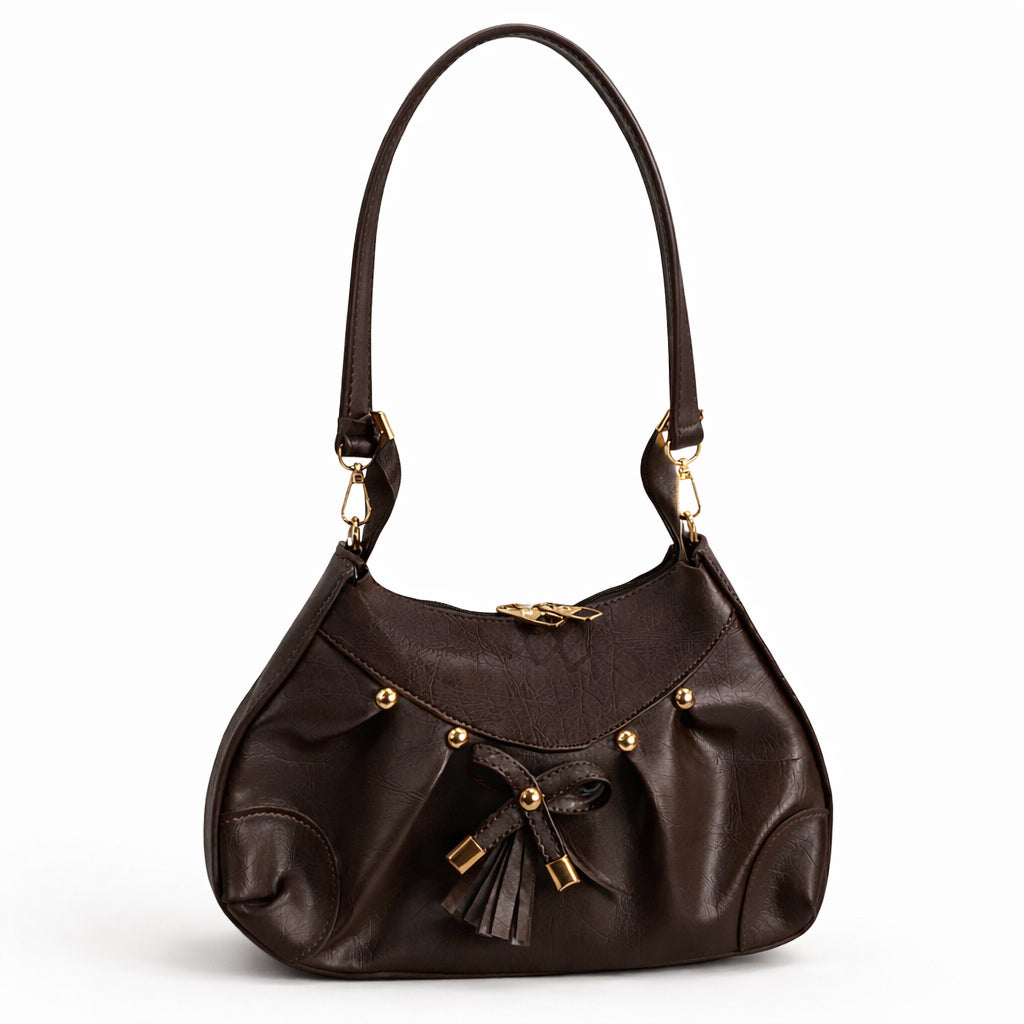 Stylish women's shoulder bag with a pleated design, featuring a bow and tassel – made of soft leather with a modern look, suitable for both formal and casual occasions.