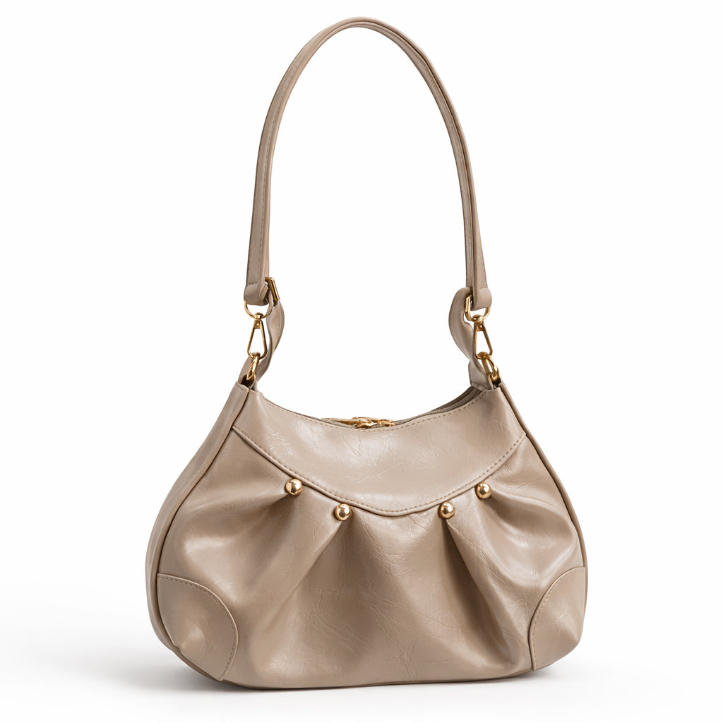 Stylish women's shoulder bag with a pleated design, featuring a bow and tassel – made of soft leather with a modern look, suitable for both formal and casual occasions.