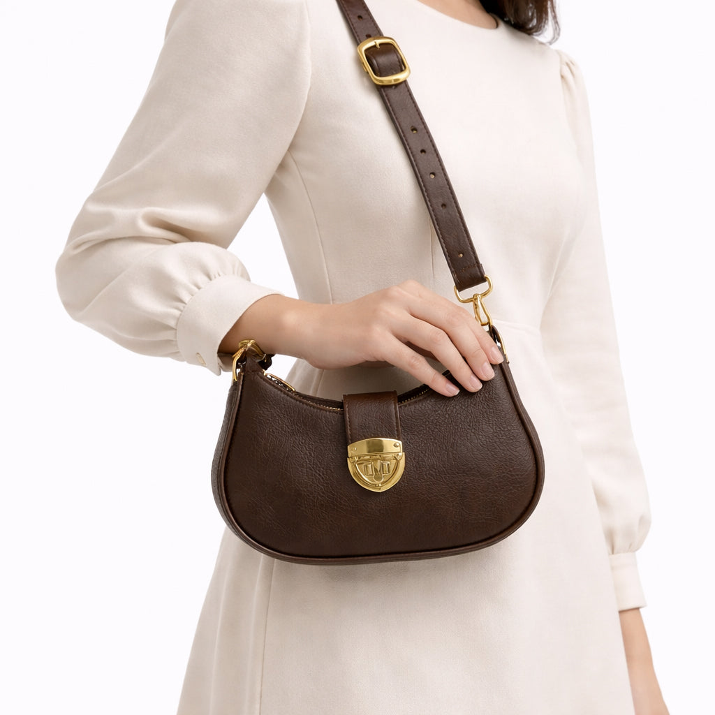 A stylish women's shoulder bag with a design that combines elegance and practicality, featuring a distinctive gold clasp and an adjustable strap.