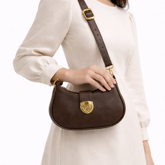 A stylish women's shoulder bag with a design that combines elegance and practicality, featuring a distinctive gold clasp and an adjustable strap.