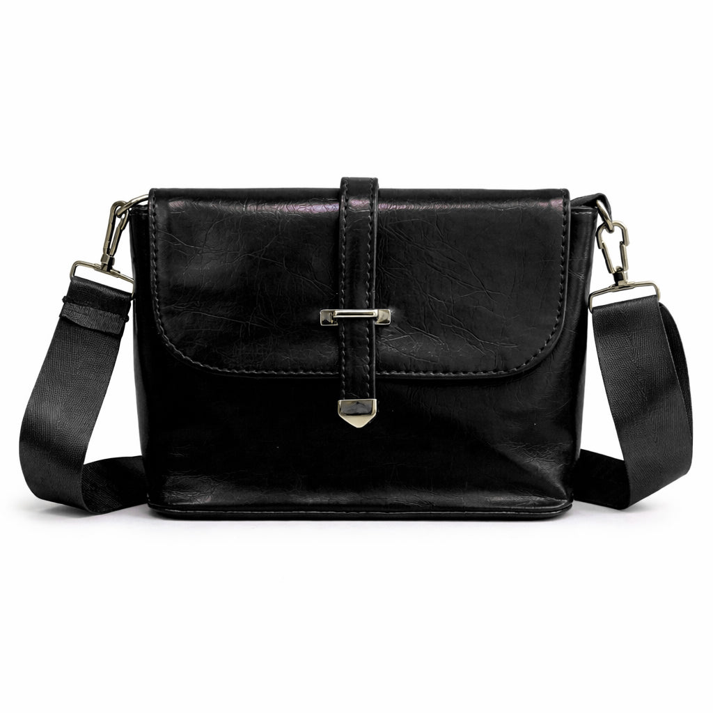 A classic women's crossbody bag in premium leather, featuring a stylish flap design, a distinctive silver metal clasp, and a wide, adjustable strap.
