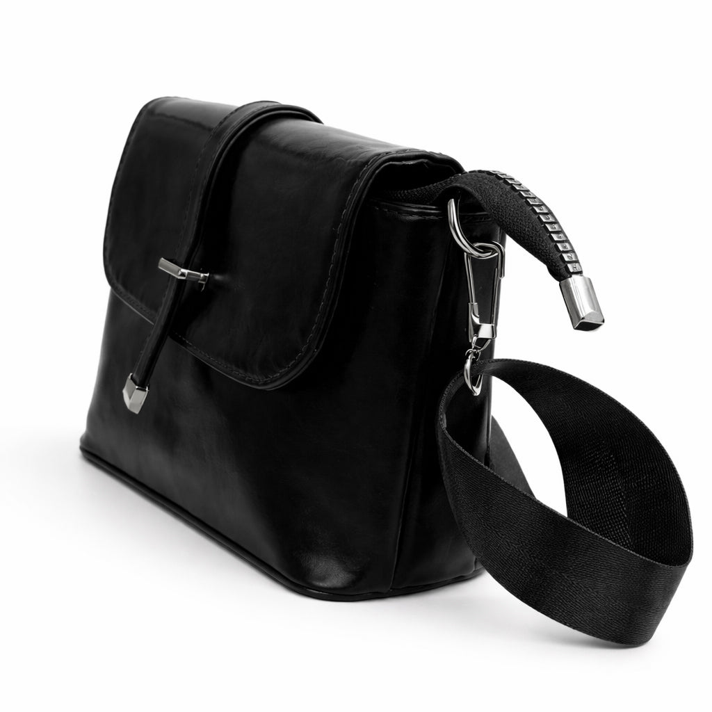 A classic women's crossbody bag in premium leather, featuring a stylish flap design, a distinctive silver metal clasp, and a wide, adjustable strap.