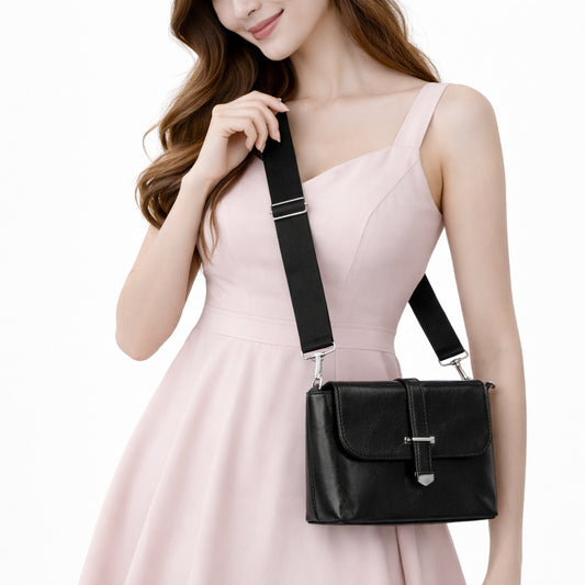 A classic women's crossbody bag in premium leather, featuring a stylish flap design, a distinctive silver metal clasp, and a wide, adjustable strap.