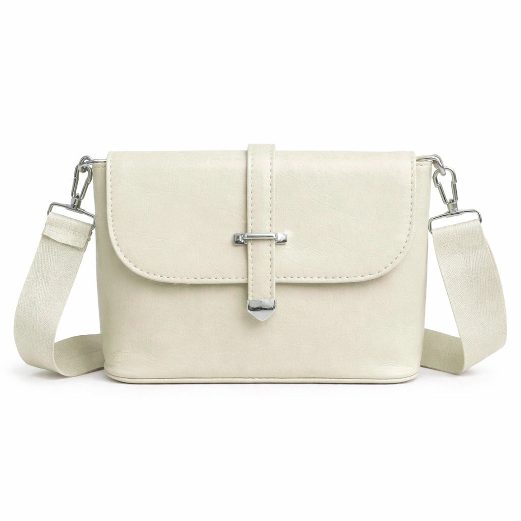 A classic women's crossbody bag in premium leather, featuring a stylish flap design, a distinctive silver metal clasp, and a wide, adjustable strap.