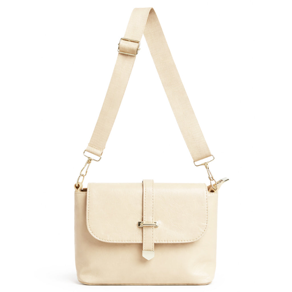A classic women's crossbody bag in premium leather, featuring a stylish flap design, a distinctive silver metal clasp, and a wide, adjustable strap.