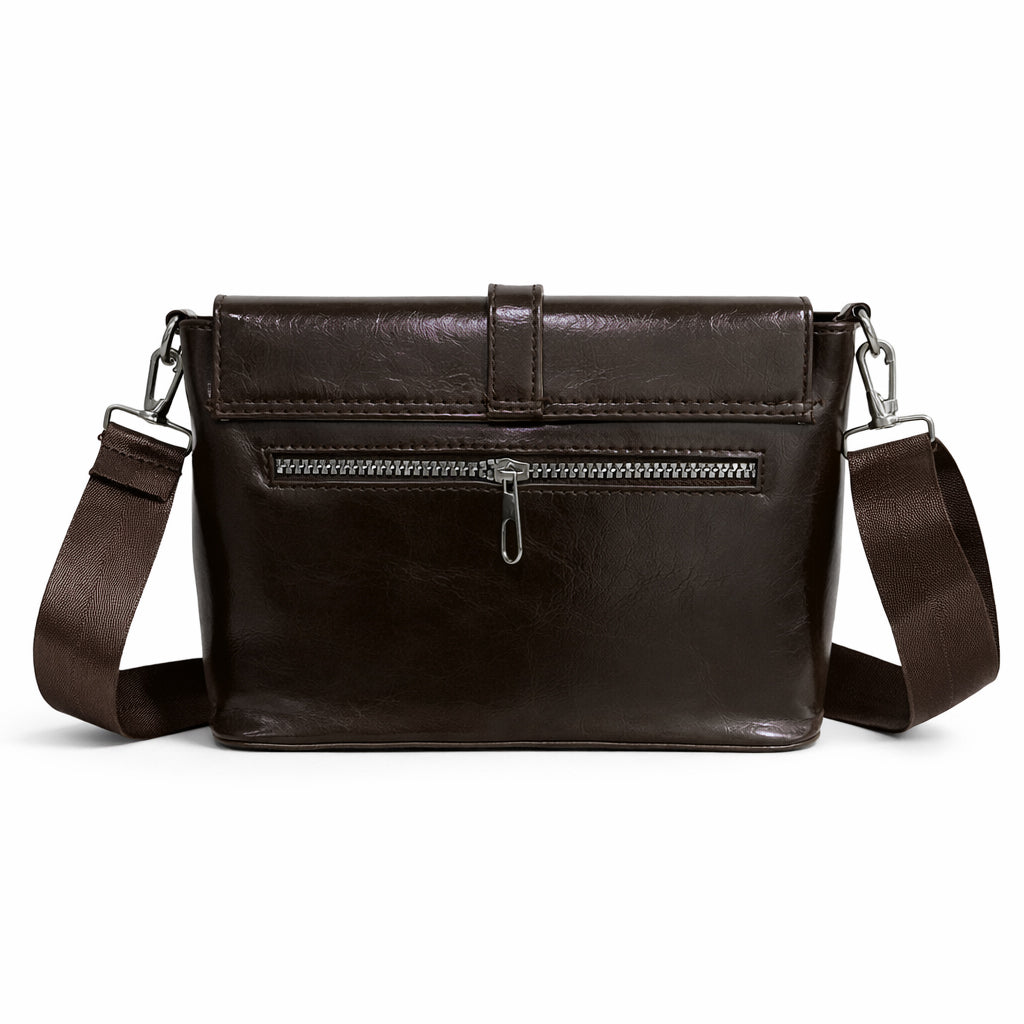 A classic women's crossbody bag in premium leather, featuring a stylish flap design, a distinctive silver metal clasp, and a wide, adjustable strap.